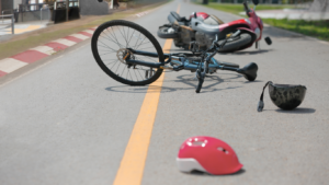 Helmet safety image. Bike and helmet on the ground after an accident.